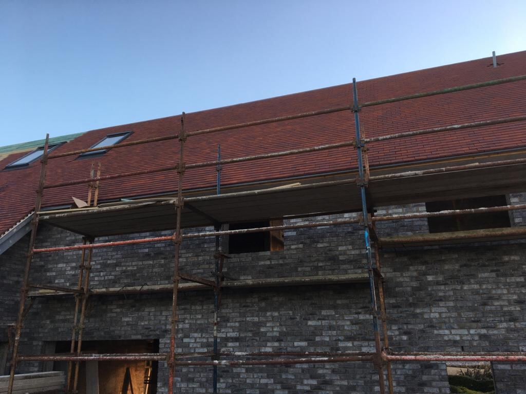 Red tiled roof with a row of roof windows
