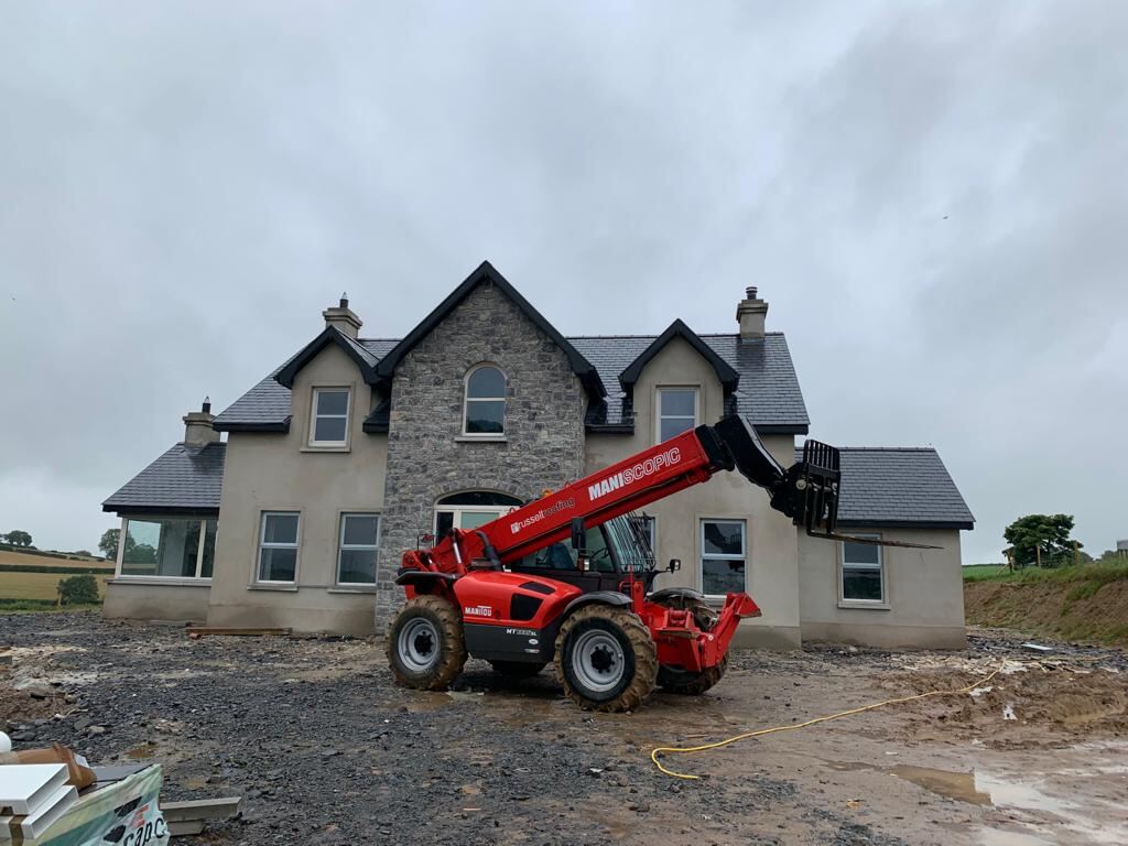 New build house with telehandler on site