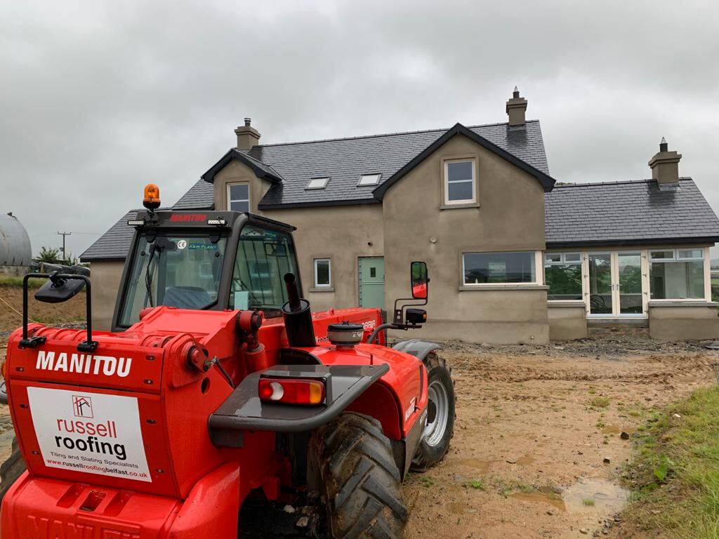 Russell Roofing branded telehandler on a building site